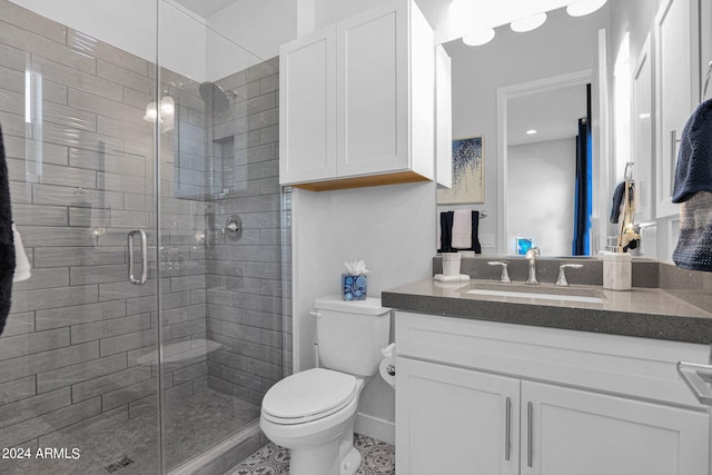 bathroom featuring toilet, tile patterned floors, walk in shower, and vanity