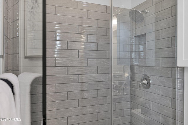 bathroom with tiled shower