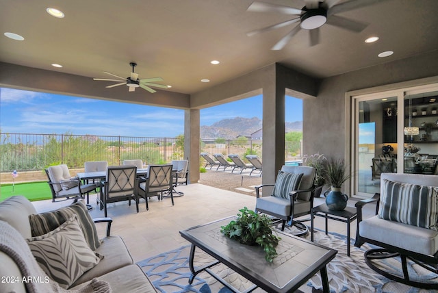 view of patio / terrace featuring an outdoor hangout area, ceiling fan, and a mountain view