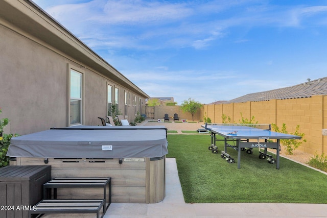 exterior space featuring a patio area and a hot tub