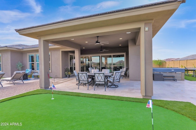 view of patio / terrace featuring ceiling fan and a hot tub