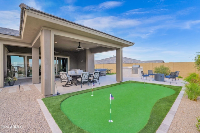 view of patio / terrace featuring exterior kitchen, grilling area, and ceiling fan