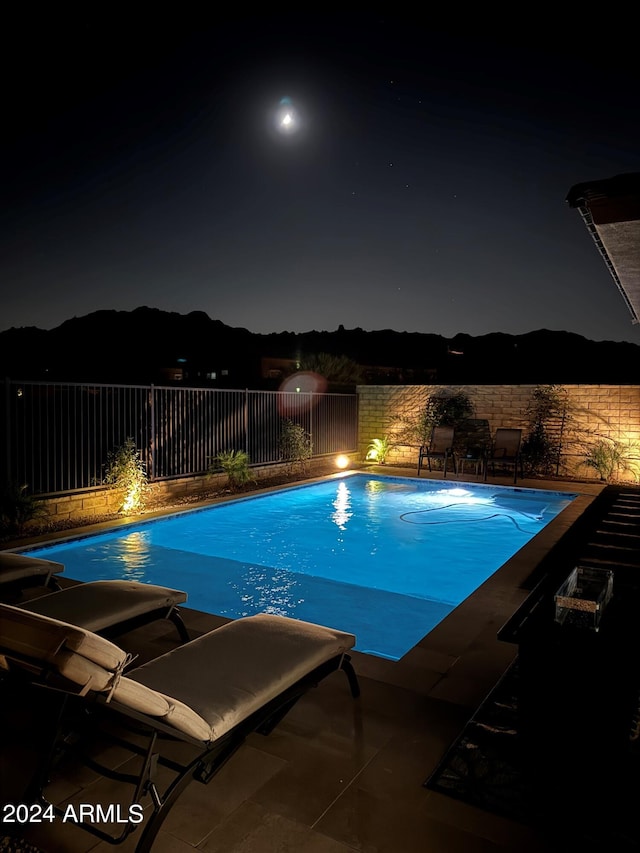 view of pool at night