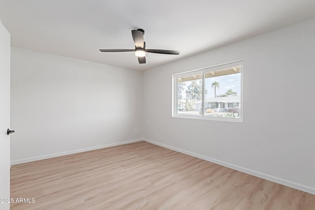 unfurnished room featuring light wood finished floors, ceiling fan, and baseboards