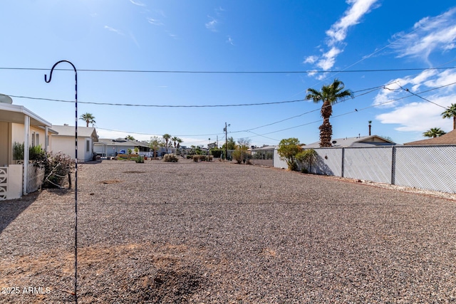 view of yard featuring fence and a residential view