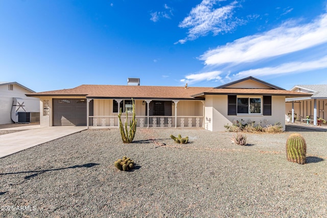 ranch-style home with a shingled roof, concrete driveway, covered porch, central AC unit, and a garage