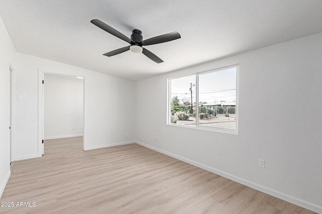 empty room featuring light wood-style floors, ceiling fan, and baseboards