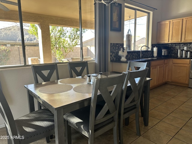 dining space featuring sink and tile patterned floors