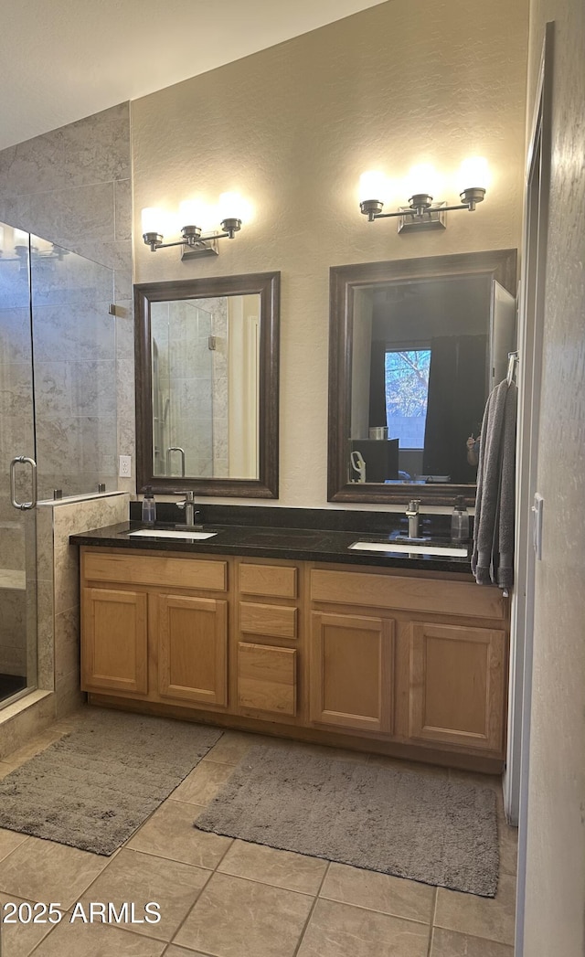 bathroom featuring walk in shower, vanity, and tile patterned flooring