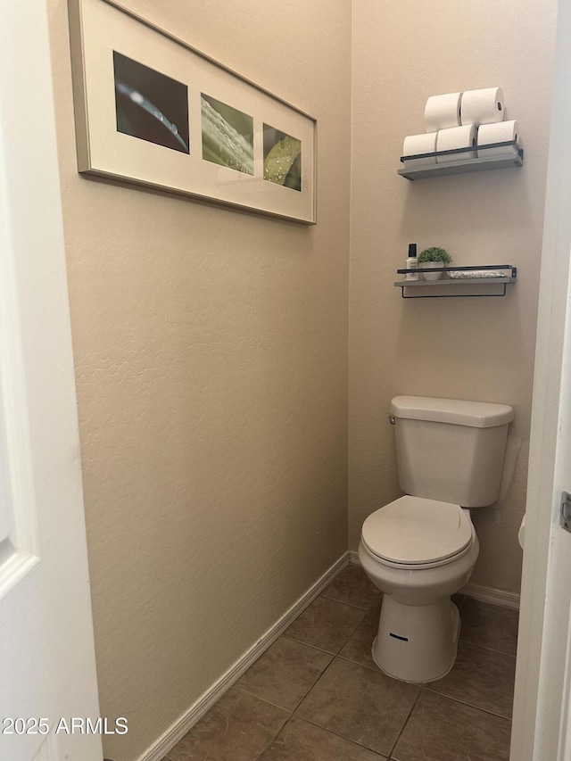 bathroom with tile patterned floors and toilet