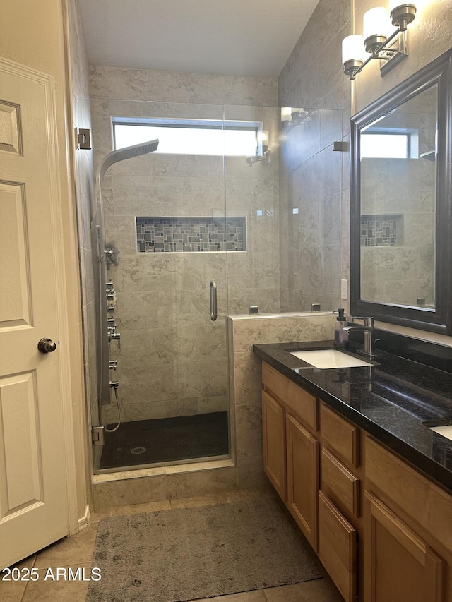 bathroom featuring vanity, tile patterned flooring, and a shower with door