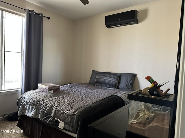 carpeted bedroom featuring multiple windows and an AC wall unit