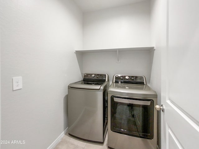 laundry area with light tile patterned floors and independent washer and dryer