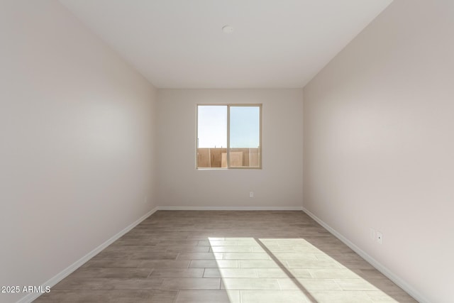 spare room with light wood-type flooring