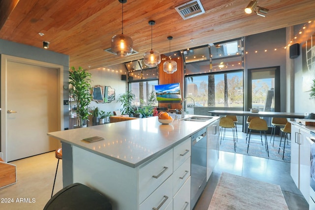 kitchen featuring white cabinetry, sink, pendant lighting, a center island with sink, and wood ceiling