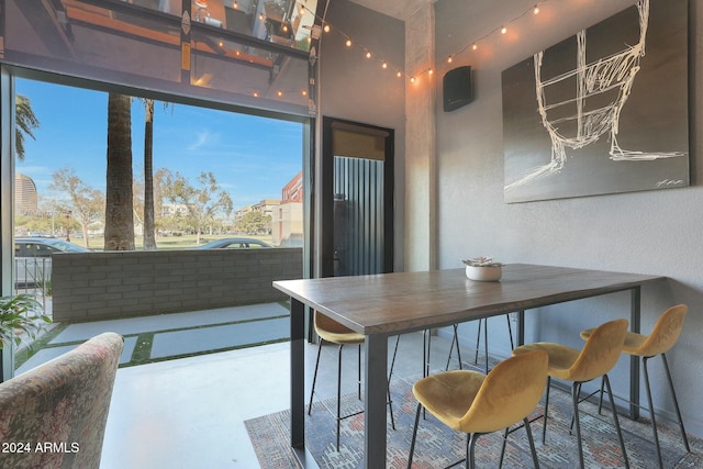 dining space featuring concrete floors