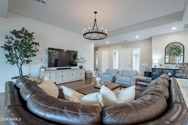 living room featuring a notable chandelier and hardwood / wood-style flooring