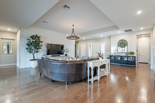 living room featuring a notable chandelier and wood-type flooring