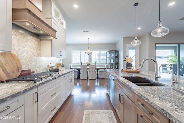 kitchen featuring sink, dark hardwood / wood-style flooring, decorative light fixtures, decorative backsplash, and white cabinets