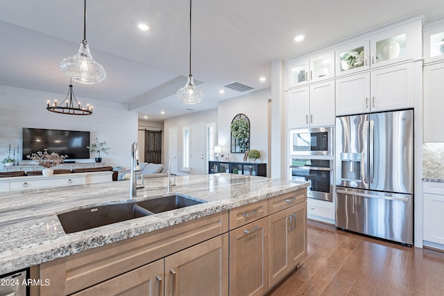 kitchen with stainless steel appliances, white cabinetry, dark hardwood / wood-style floors, sink, and light stone countertops