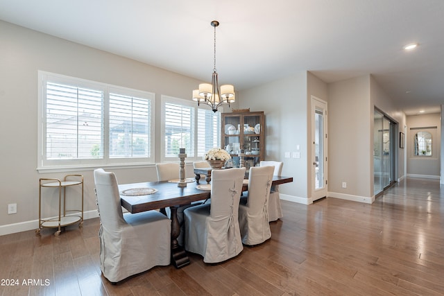 dining space featuring a notable chandelier and dark hardwood / wood-style flooring