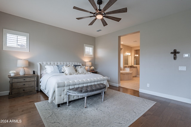 bedroom with ceiling fan, multiple windows, dark hardwood / wood-style flooring, and ensuite bath