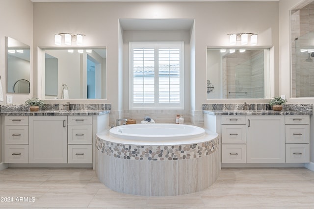 bathroom featuring tile patterned floors, shower with separate bathtub, and vanity