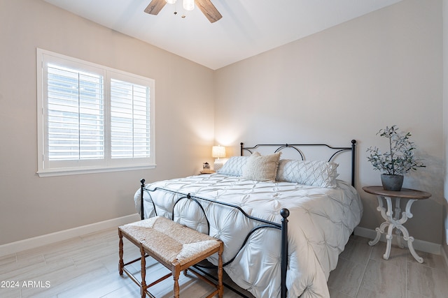 bedroom with ceiling fan and light hardwood / wood-style floors