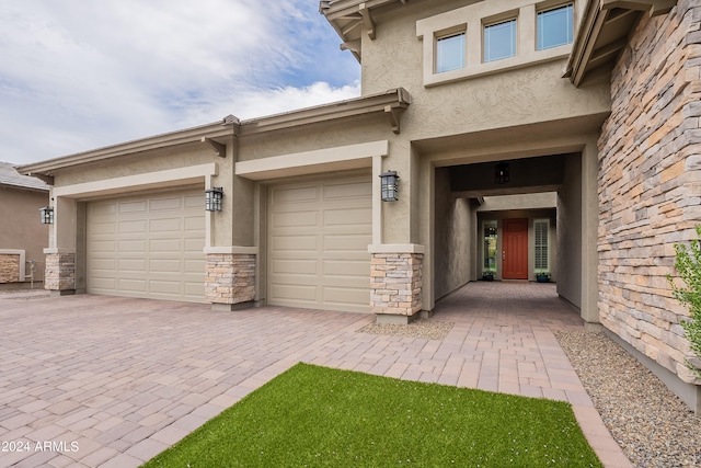 doorway to property with a garage