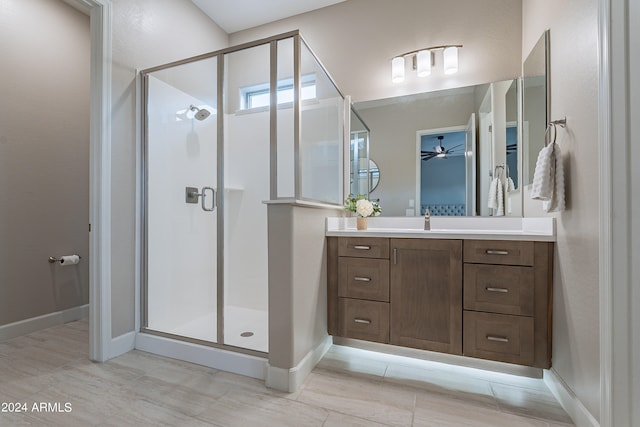 bathroom featuring ceiling fan, a shower with door, tile patterned floors, and vanity