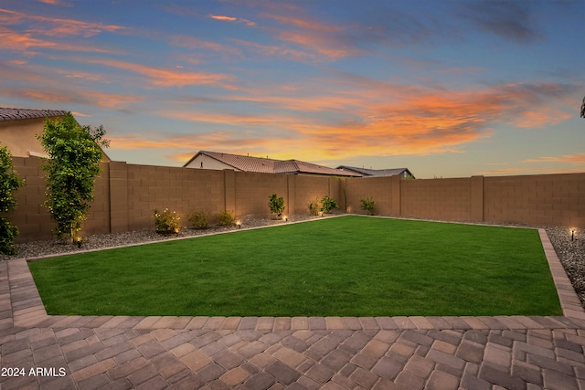 yard at dusk with a patio