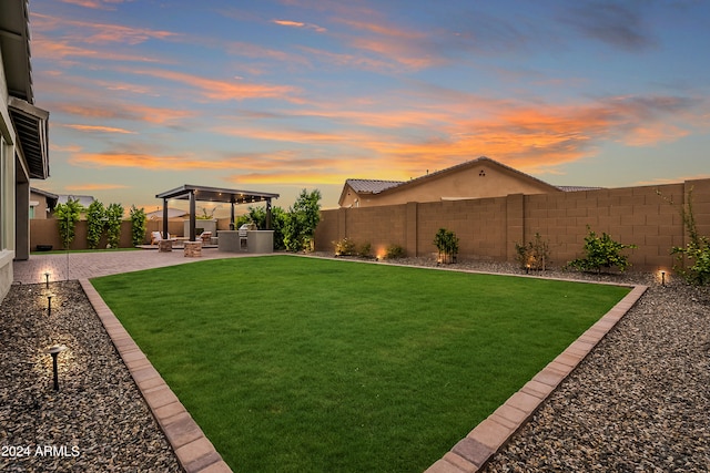 yard at dusk featuring a patio area