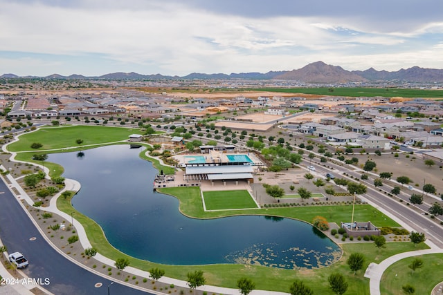 birds eye view of property with a water and mountain view