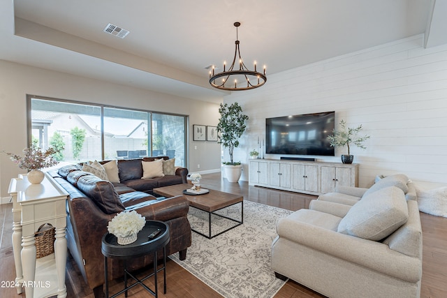 living room with dark hardwood / wood-style floors and a chandelier