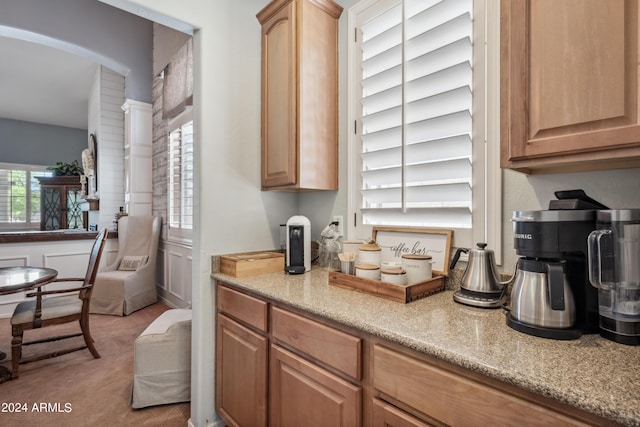 kitchen featuring light colored carpet and arched walkways