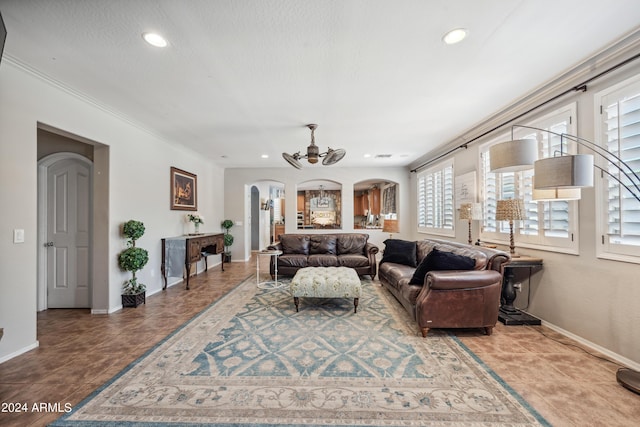 living area with arched walkways, baseboards, a ceiling fan, and recessed lighting