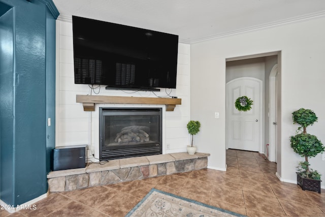 living area with crown molding, baseboards, tile patterned flooring, and a fireplace