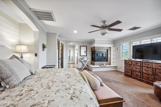 bedroom with crown molding, arched walkways, carpet floors, and visible vents