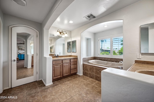 full bathroom with visible vents, tile patterned floors, a bath, and vanity
