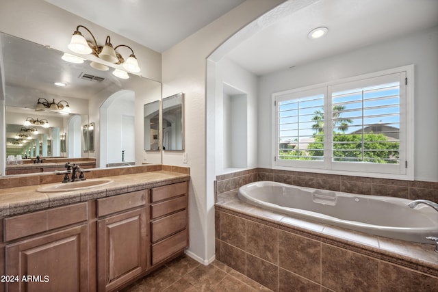 bathroom featuring vanity, tile patterned flooring, a garden tub, and visible vents