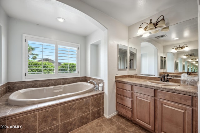 bathroom featuring tile patterned flooring, visible vents, a bath, and vanity