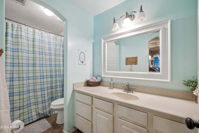 bathroom featuring toilet, visible vents, curtained shower, and vanity