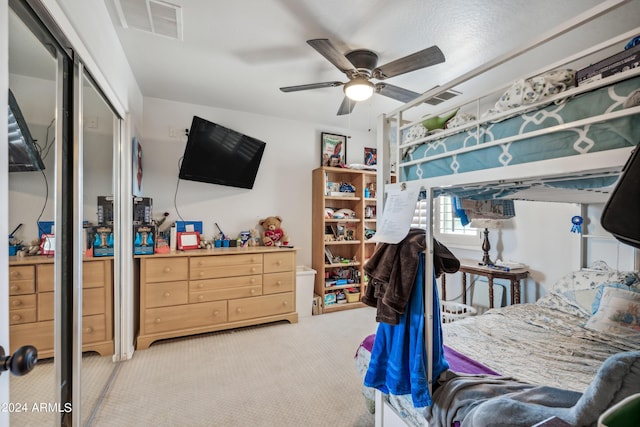 bedroom featuring ceiling fan, carpet, a closet, and visible vents