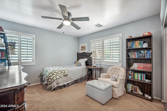 carpeted bedroom featuring visible vents, baseboards, and ceiling fan