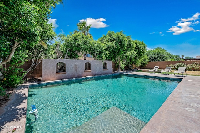 view of swimming pool featuring a fenced backyard, a fenced in pool, and a patio