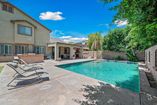 view of swimming pool featuring a patio, a fenced in pool, and a fenced backyard