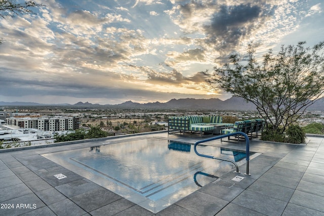 pool at dusk with a mountain view