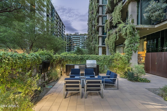 view of patio / terrace featuring exterior kitchen, a grill, and an outdoor living space