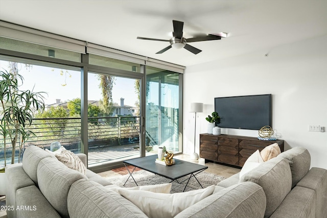 living room featuring ceiling fan and floor to ceiling windows