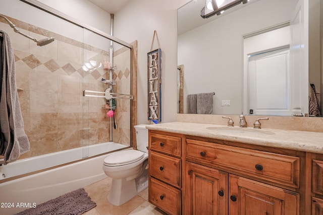 full bathroom with tile patterned floors, combined bath / shower with glass door, vanity, and toilet